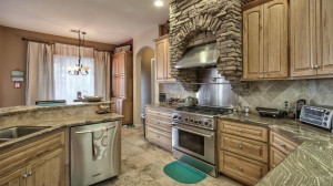 Granite countertops, solid hickory cabinets, a commercial gas stove and top-of-the-line Kitchen Aid stainless steel appliances, including a trash compactor.